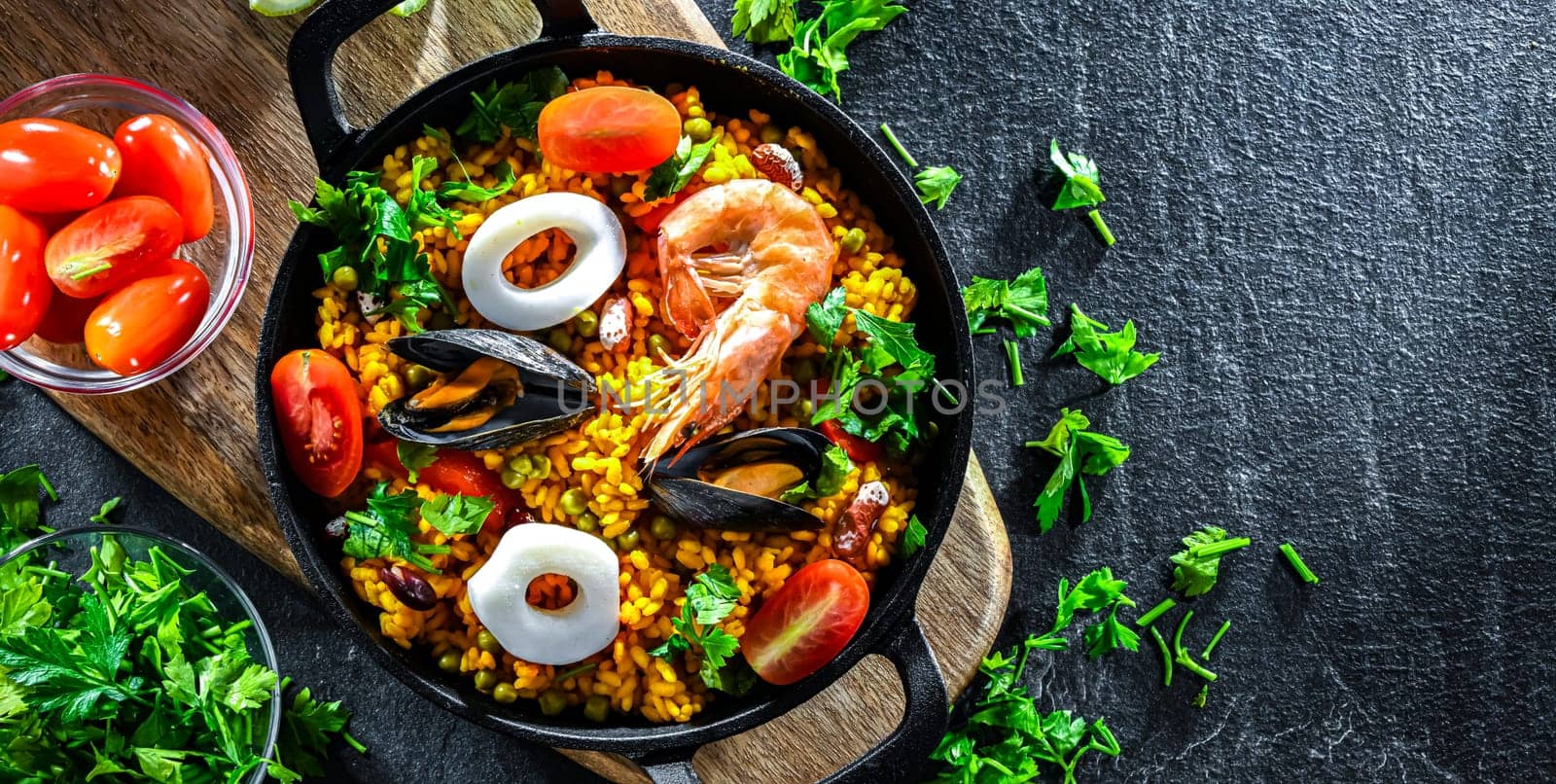 Seafood paella served in a cast iron pan.