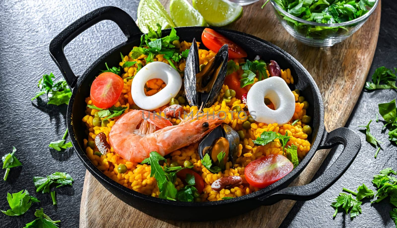 Seafood paella served in a cast iron pan.