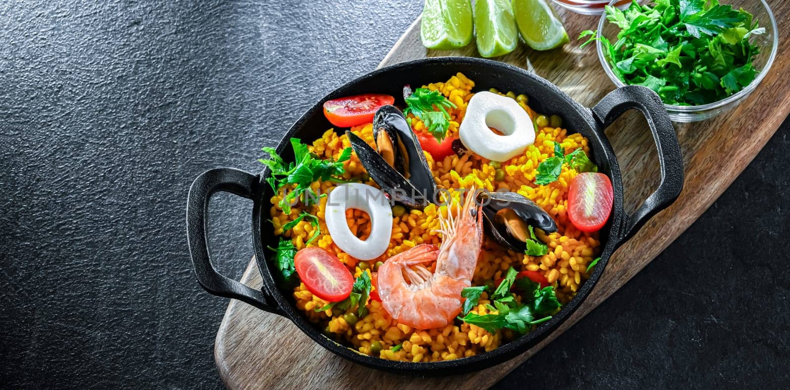 Seafood paella served in a cast iron pan.