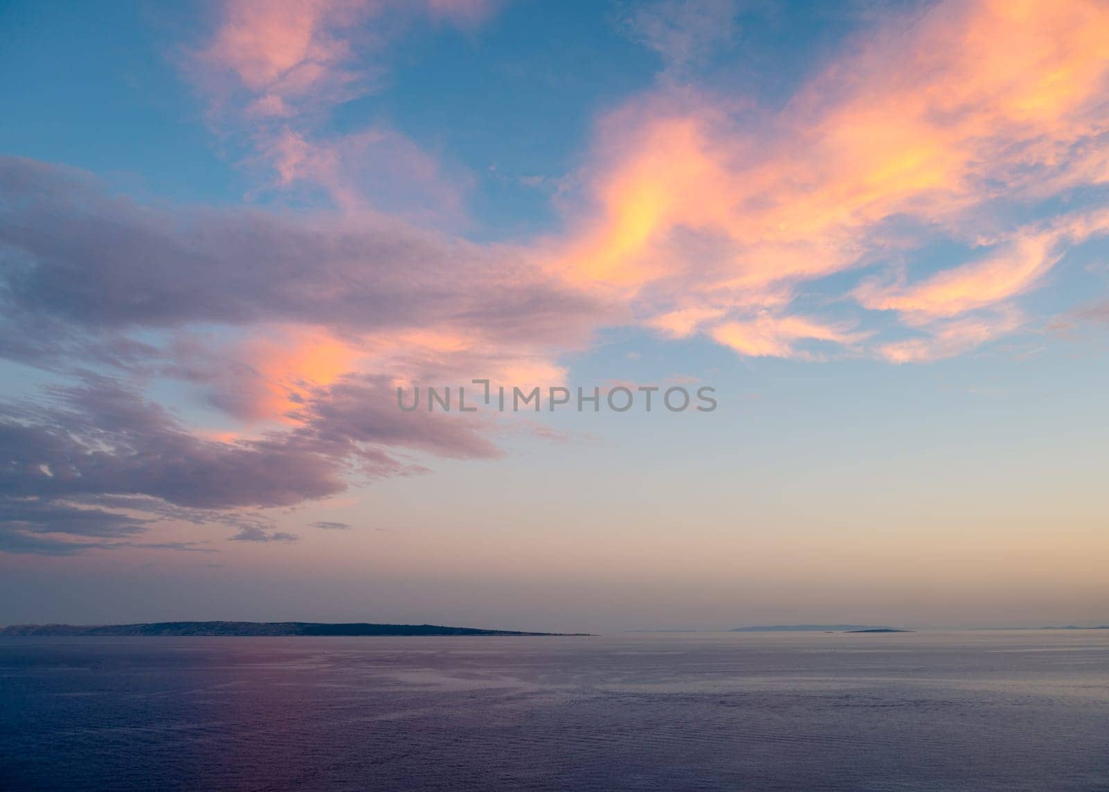 Evening sky with dramatic clouds over the sea. Dramatic sunset over the sea.