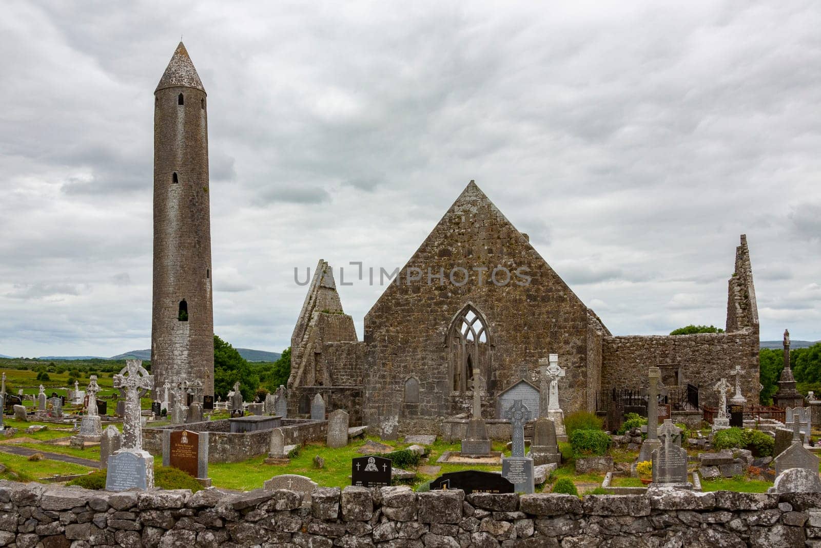 The ruins of Kilmacduagh Monastery near the town of Gort in County Galway, Republic of Ireland. The abbey was founded by Saint Colman, son of Duagh in the early 7th century.