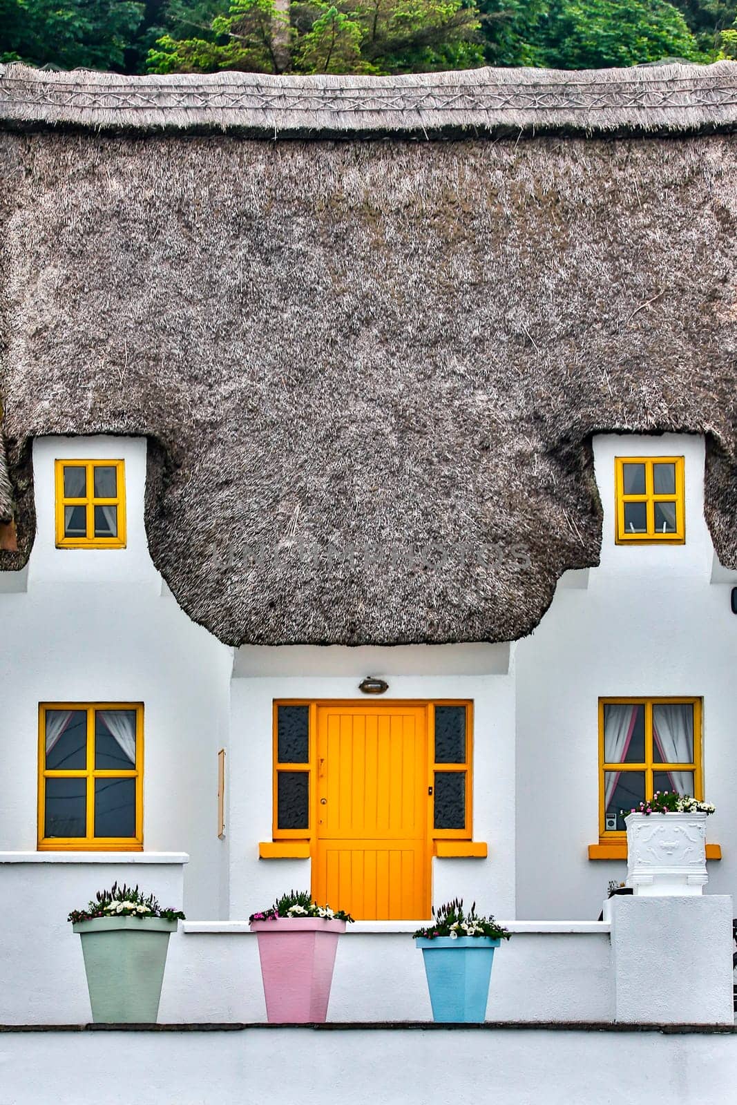 Thatched cottage in the popular tourist and fishing village of Dunmore East in County Waterford, Republic of Ireland.