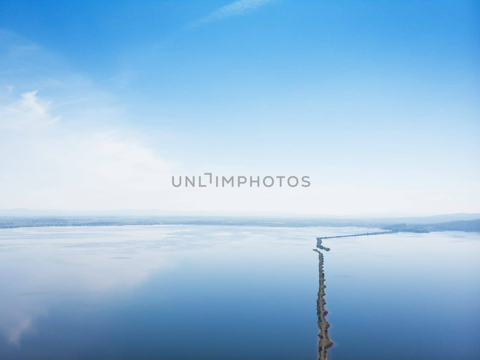 Aerial drone view of sea landscape with road in sunny summer