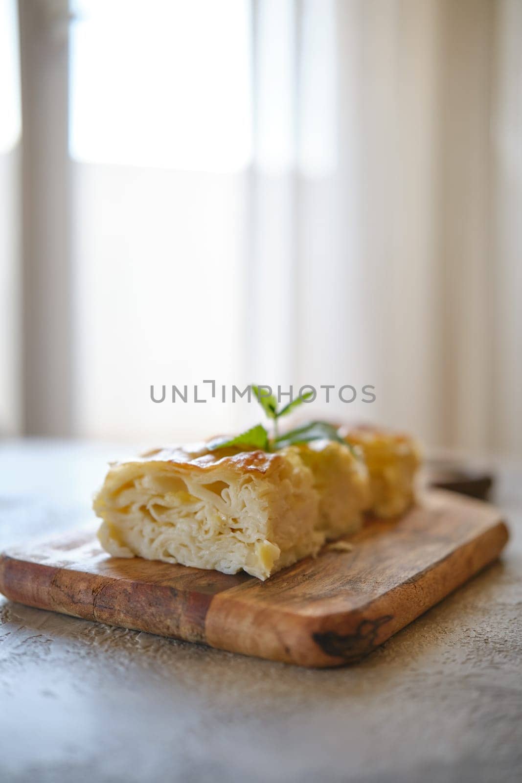 Georgian cheese pie Achma cut on pieces on a table