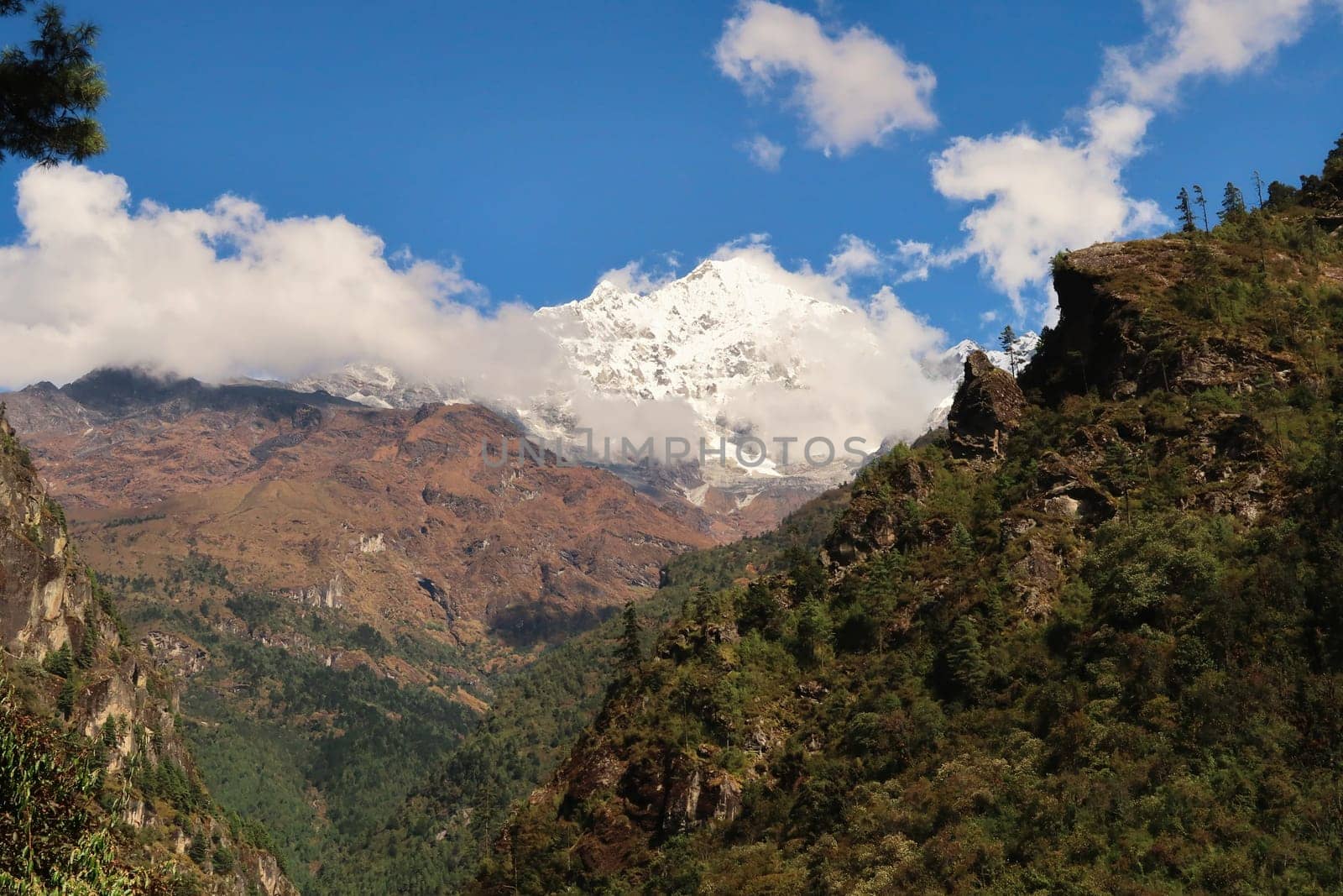 View on to the snow covered peak of Mount Thamserku seen on the trail between Tok Tok village and Benkar village on the Mount Everest Basecamp Trek, EBC, Nepal 2022