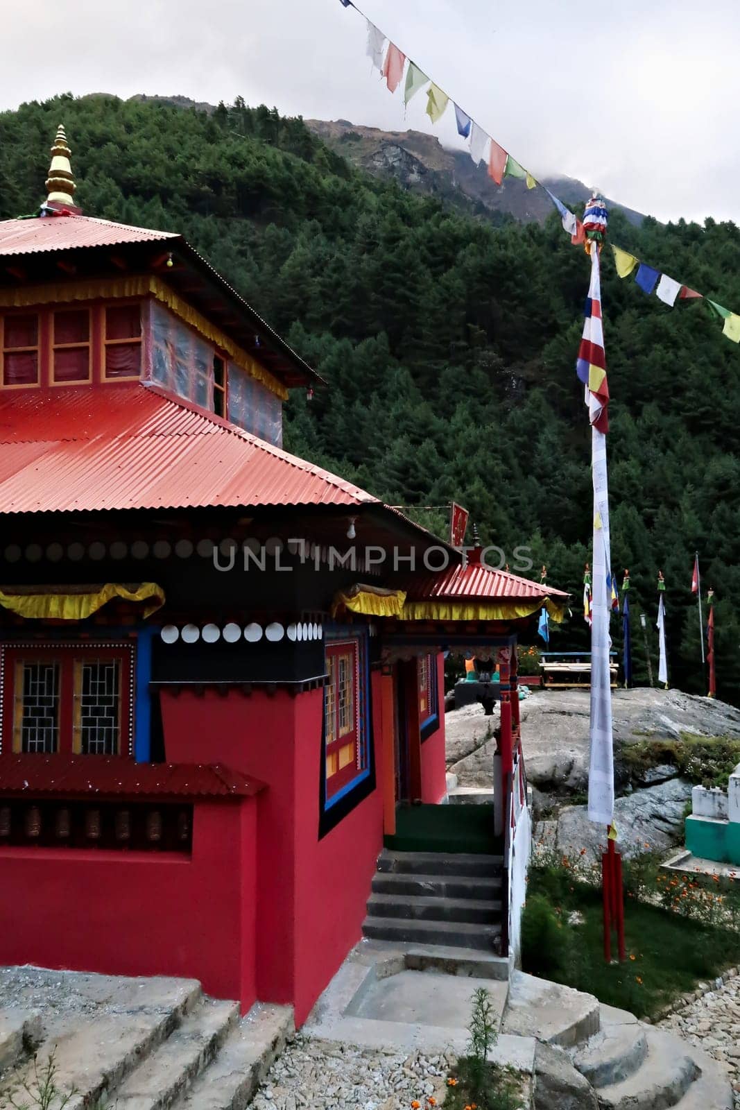 The red main building of the monastery built on a hill in the Monjo, Manjo village on the Mount Everest Basecamp Trek, EBC, Nepal 2022
