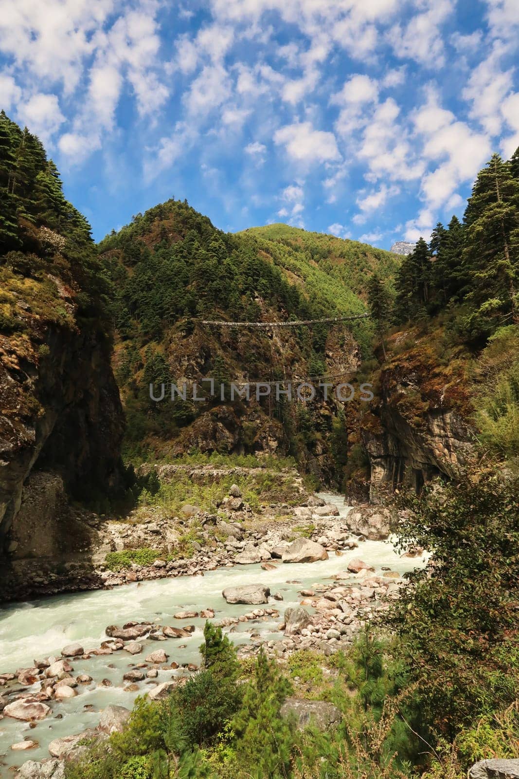 View onto the famous Hillary bridge, a double suspension bridge over the Dudh Khosi River between Phakding and Namche Bazar, Bazaar, Mount Everest Basecamp Trek, EBC, Nepal 2022