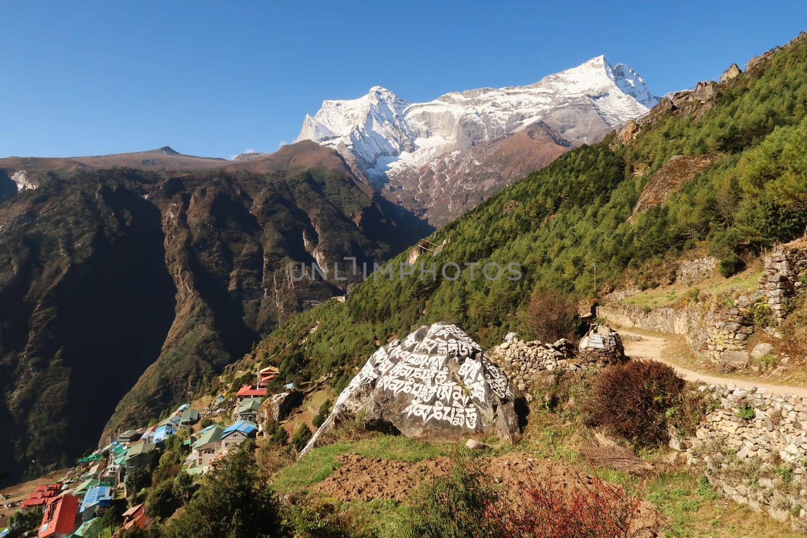 On the trail above Namche Bazaar, Bazar with the Kongde Ri peak in the background and a Mani Stone in the foreground, Mount Everest Basecamp Trek, Nepal 2022