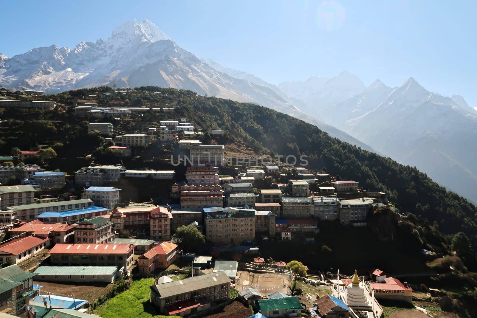 View over Namche Bazar, Bazaar, mountains are rising in the background, Mount Kusum Kanguru, Kangguru on the right and Mount Thamserku on the left, Mount Everest Basecamp Trek, EBC, Nepal 2022