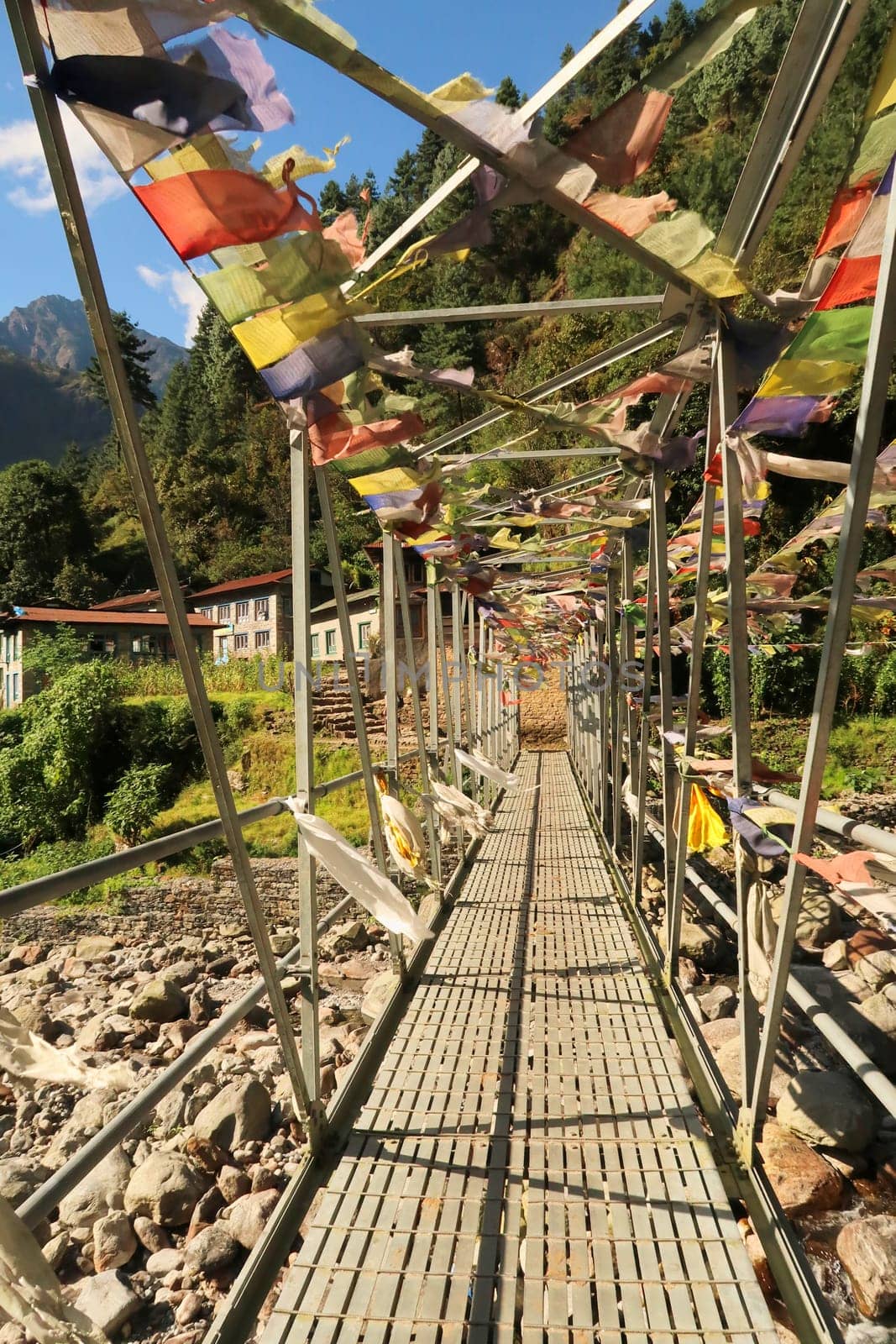 Metal bridge with prayer flags between Salleri and Lukla, Mount Everest Basecamp Trek, Nepal 2022