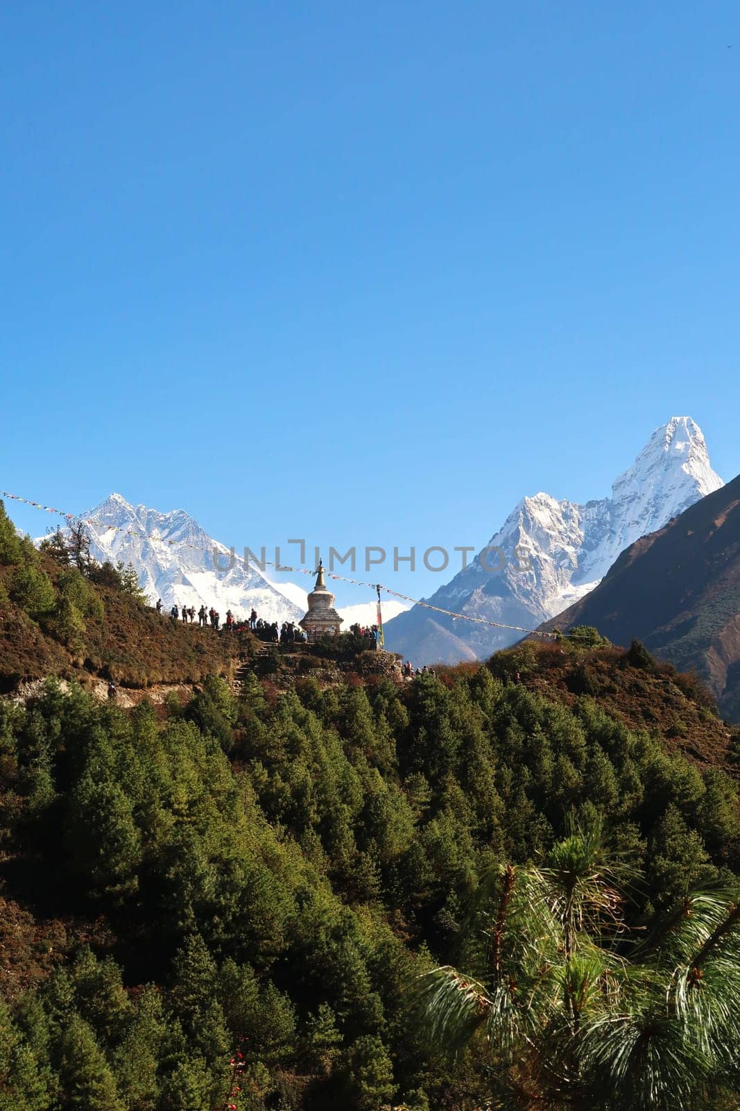 View onto the Tenzing Norgay Memorial Chhorten, Stupa near Namche Bazaar, Bazar, many people are gathering in the foreground, Lhotse and Ama Dablam can be seen in the background, Mount Everest Basecamp Trek, EBC, Nepal 2022