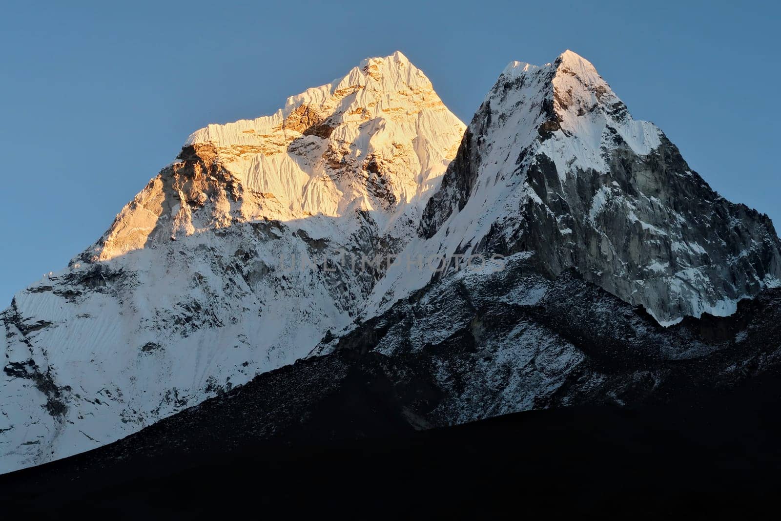 The snow capped peaks of Mount Amphu Gyabjen and Mount Ama Dablam at sunset, Dingboche village, Mount Everest Base Camp Trek, EBC, Nepal 2022