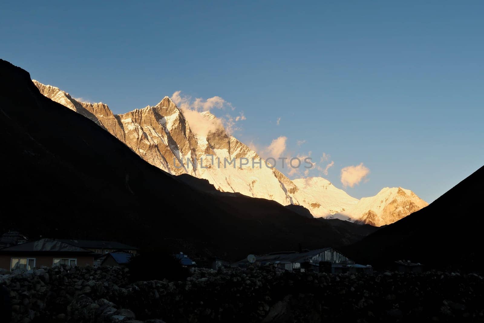 Dingboche around sunset, the village in the foreground is already dark when golden light is still shining on Mount Lhotse and the Island Peak in the background, Mount Everest Base Camp Trek, EBC, Nepal 2022