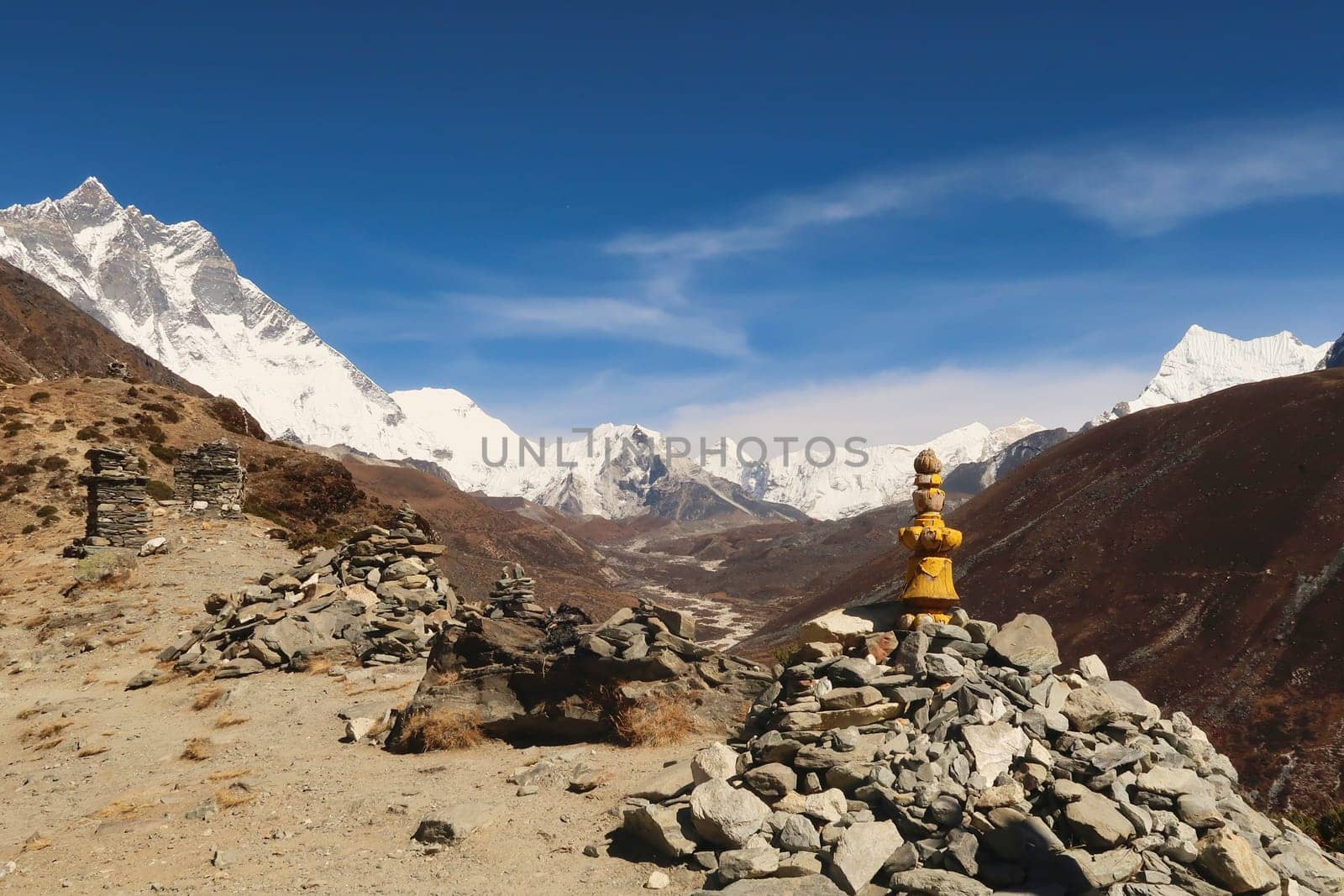 Stacks, piles of stones, rocks on the way to the Dingboche view point, Mount Lhotse and Island peak can be seen in the background, Mount Everest Base Camp Trek, EBC, Nepal 2022