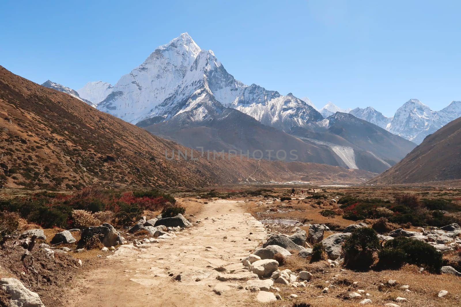 Walking through Pheriche valley, Pheriche village in the distance in front of Mount Amphu Gyabjen, Ama Dablam, Kangtega and Thamserku, Mount Everest Base Camp Trek, EBC, Nepal 2022