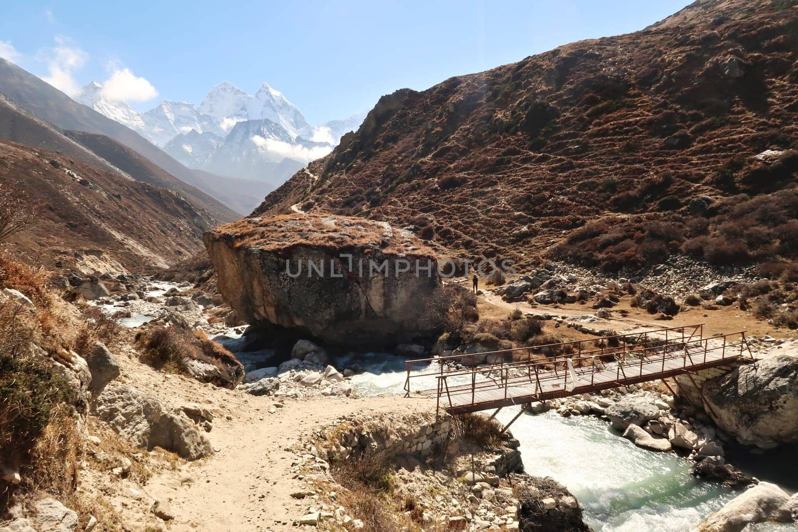 Little wooden bridge over the Lobuche River on the trail between Pheriche and Pangboche, Mount Kangtega and Thamserku in the background, Mount Everest Base Camp Trek, EBC, Nepal 2022