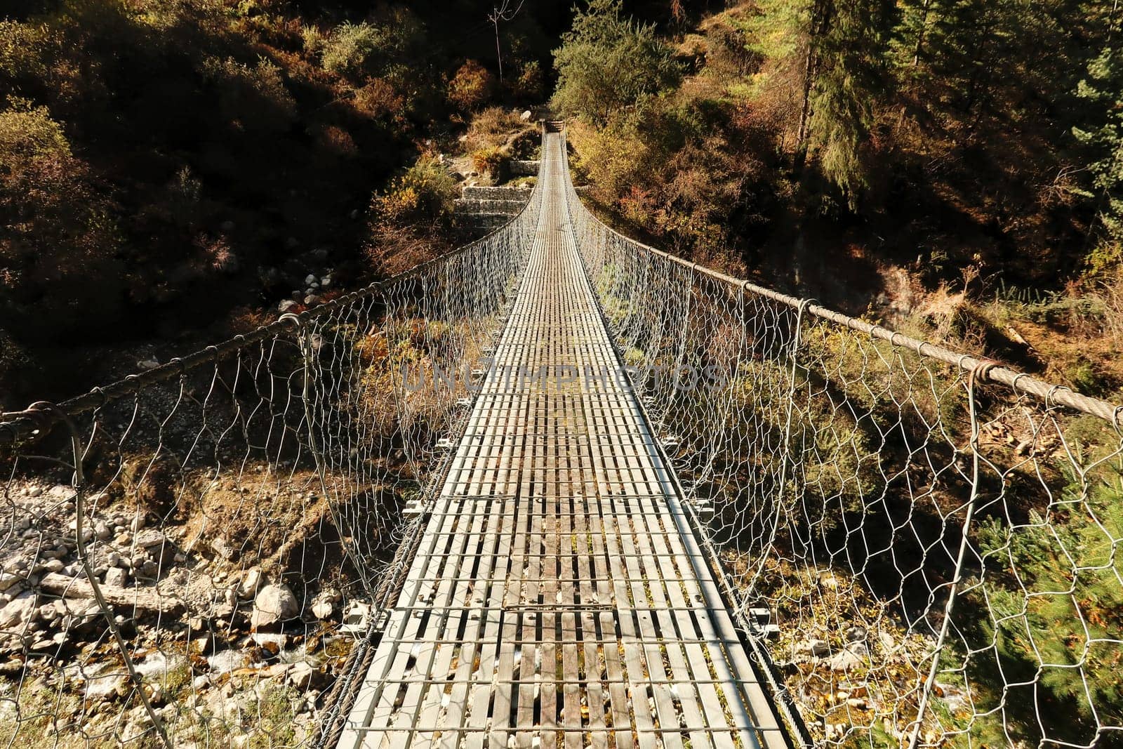 Long metal suspension bridge before entering the village of Timang, Annapurna Circuit Trek, Nepal 2022
