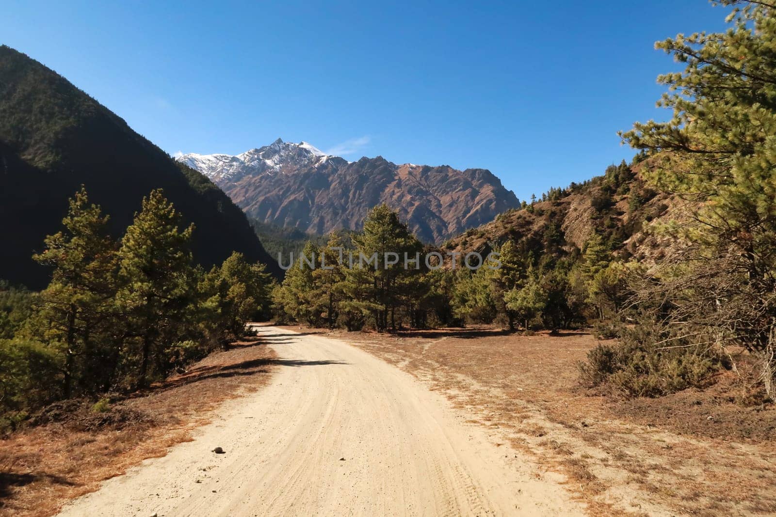 On the trail, road between Dhukur, Dhikur Pokhari and Upper Pisang, the northern ridge of Annapurna II rises in the background, Annapurna Circuit Trek, Nepal 2022