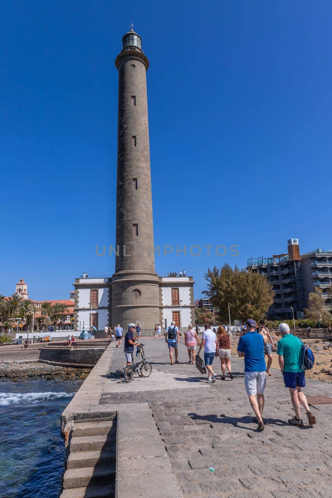 Gran Canaria, Spain: March 20, 2024: People near the Maspalomas Lighthouse in Gran Canaria Canary Island.This highest lighthouse on the island,a landmark in this important tourist destination
