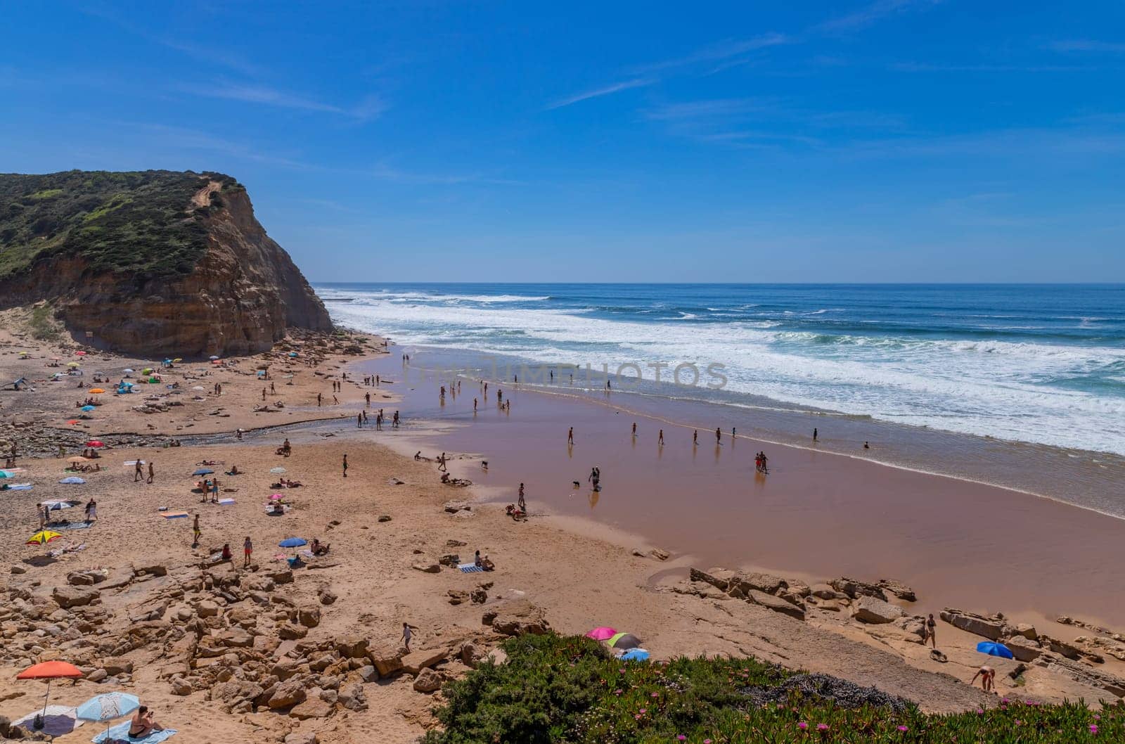 Sintra, Portugal: April 13, 2024: People at the beach of Sao Juliao, Mafra, Portugal