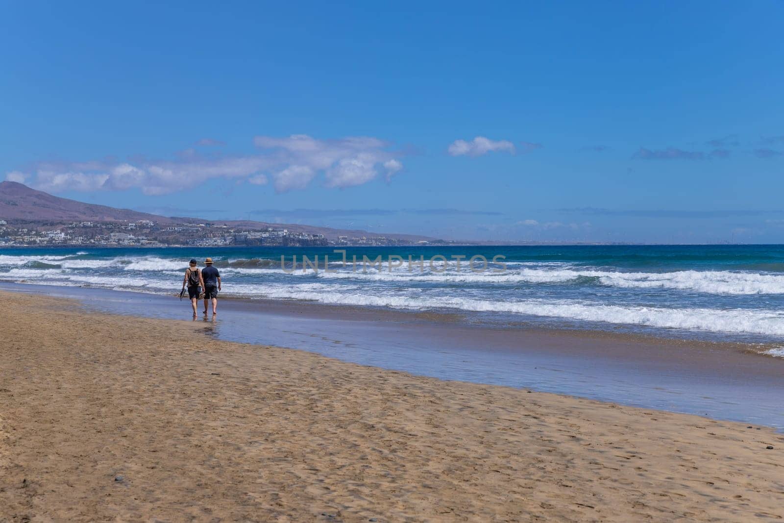 Gran Canaria, Spain - March 20, 2024: People visit Playa Ingles beach in Maspalomas, Gran Canaria. Spain