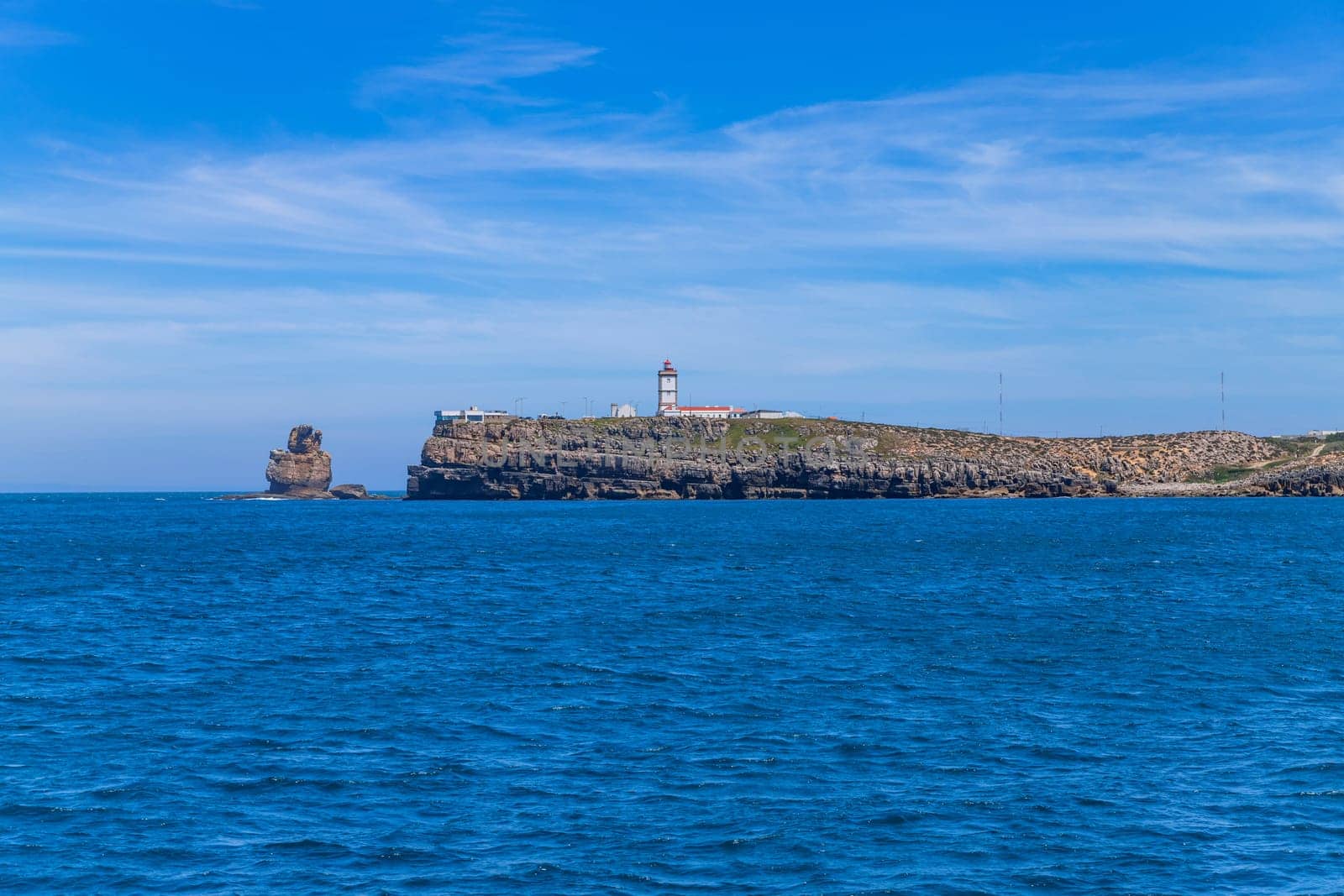 Lighthouse and cliffs of Carvoeiro cape in Peniche, Atlantic coast, Portugal