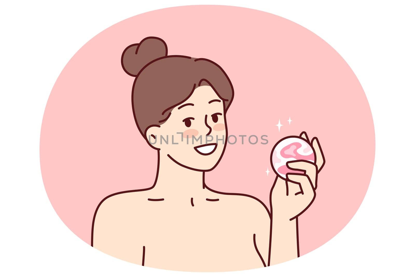 Woman with bath bomb in hands smiles as she prepares to take bath with aromatic substances. Happy girl with bare shoulders demonstrates bomb for comfortable water treatments or SPA