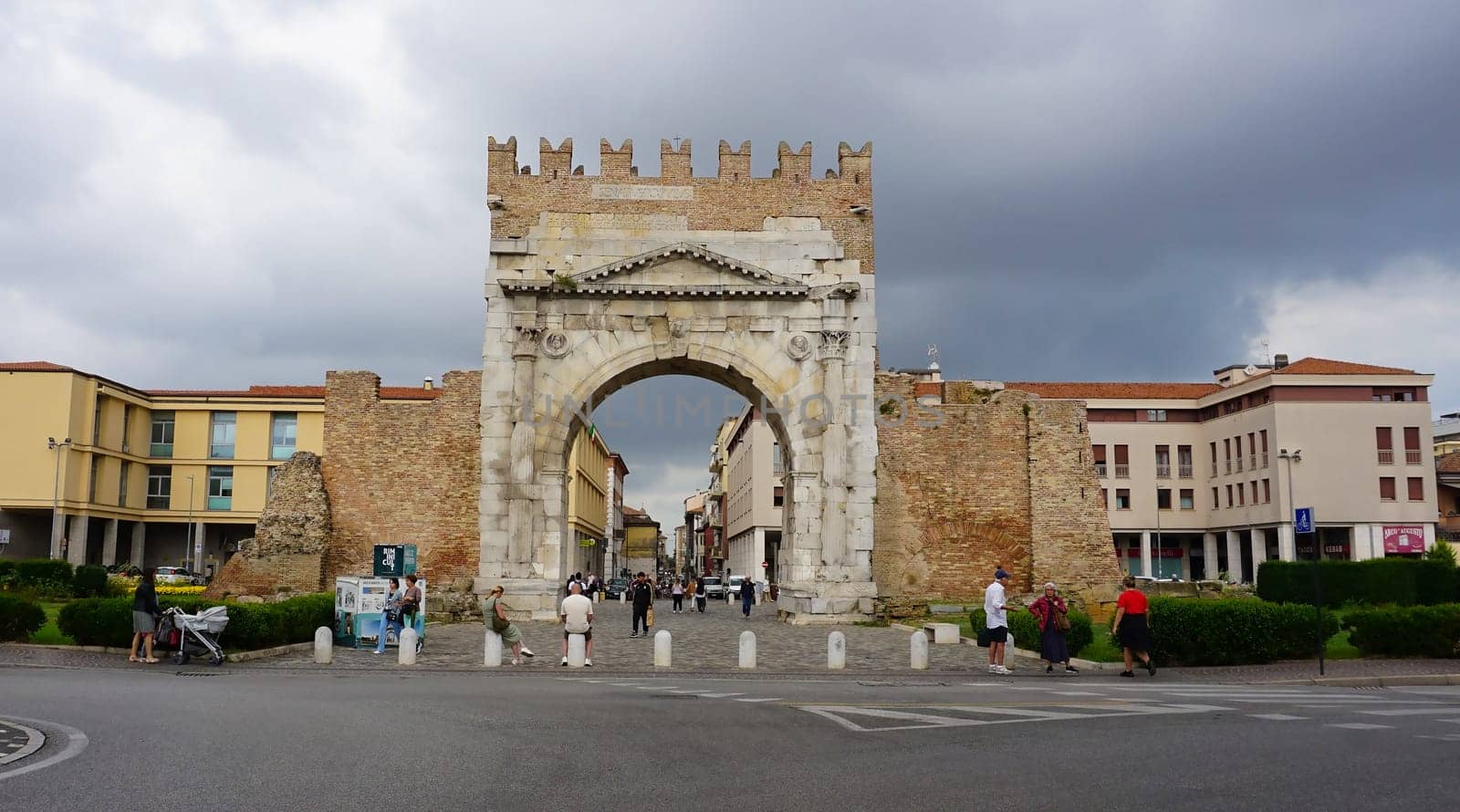 Rimini, Italy - June 25, 2024: People are passing Arch of Augustus, triumphal ancient architecture of Roman Empire, 27 BC at Italy