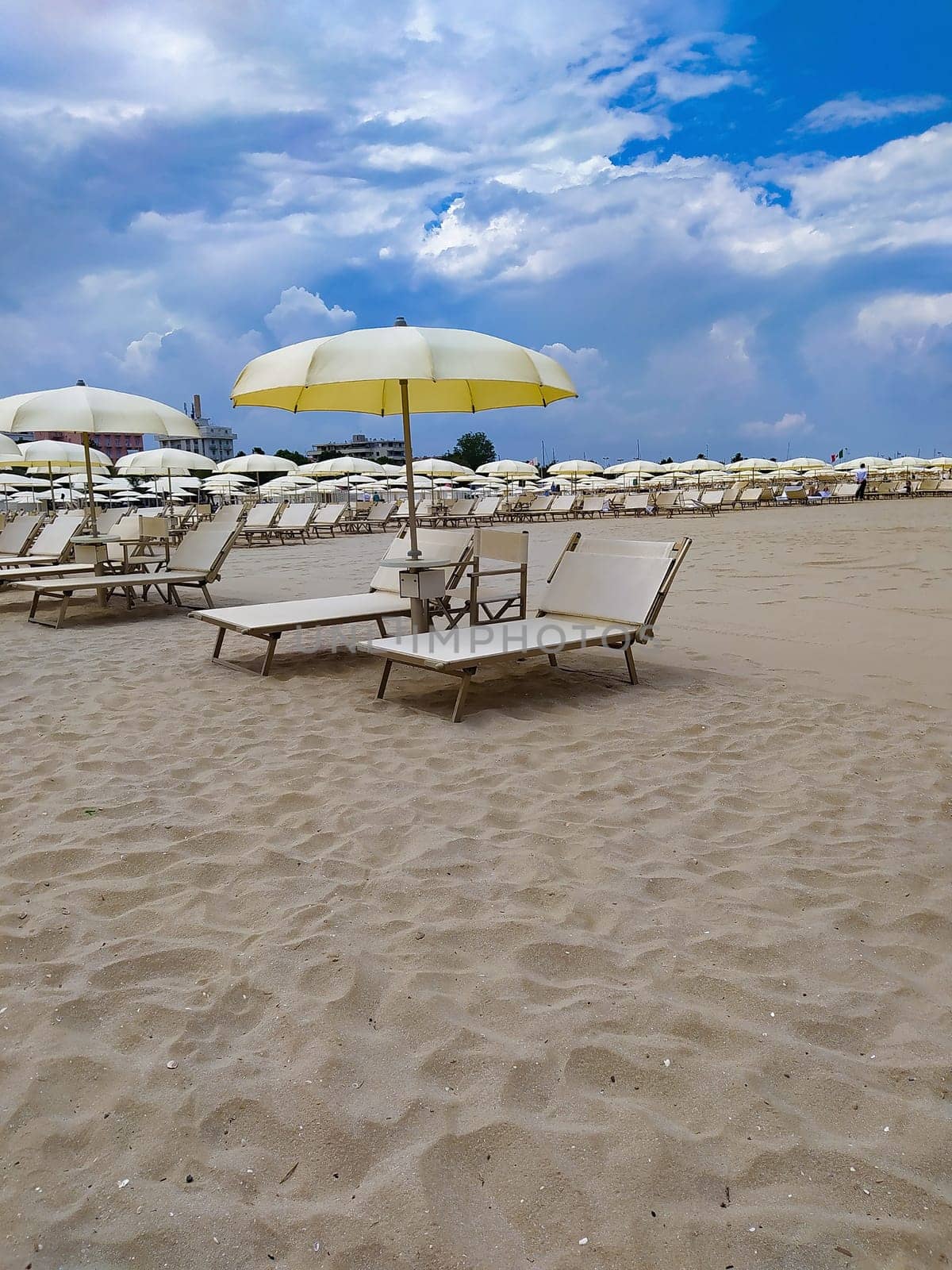 Summer. The sunbeds and parasols on the empty beach
