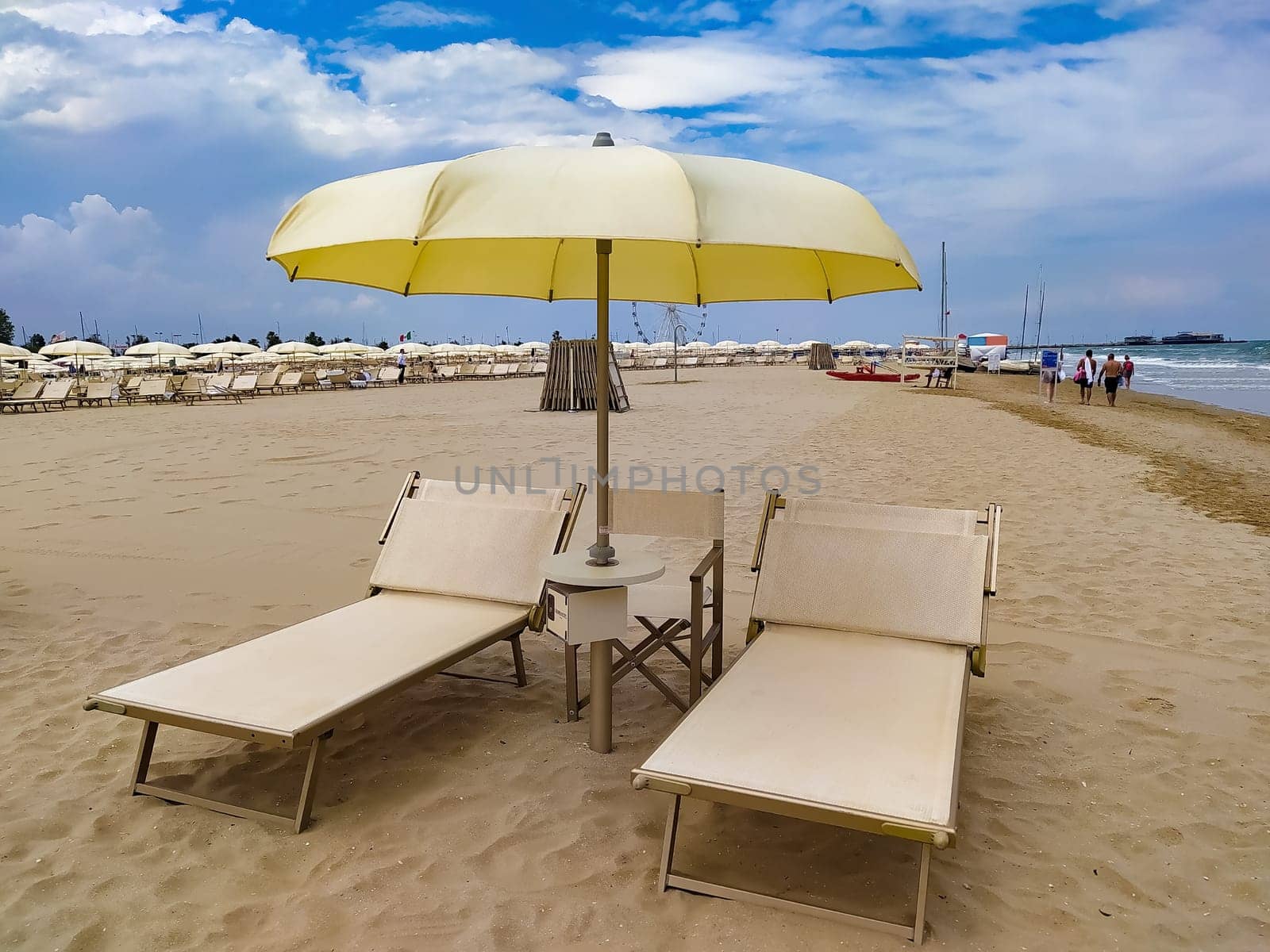 Summer. The sunbeds and parasols on the empty beach