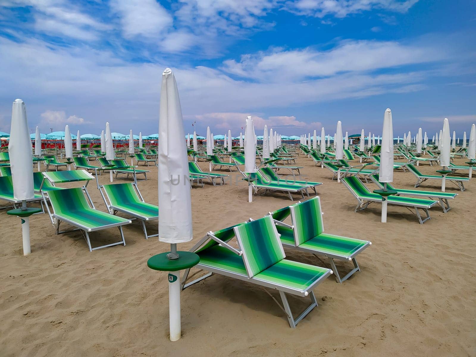 Summer. The sunbeds and parasols on the empty beach