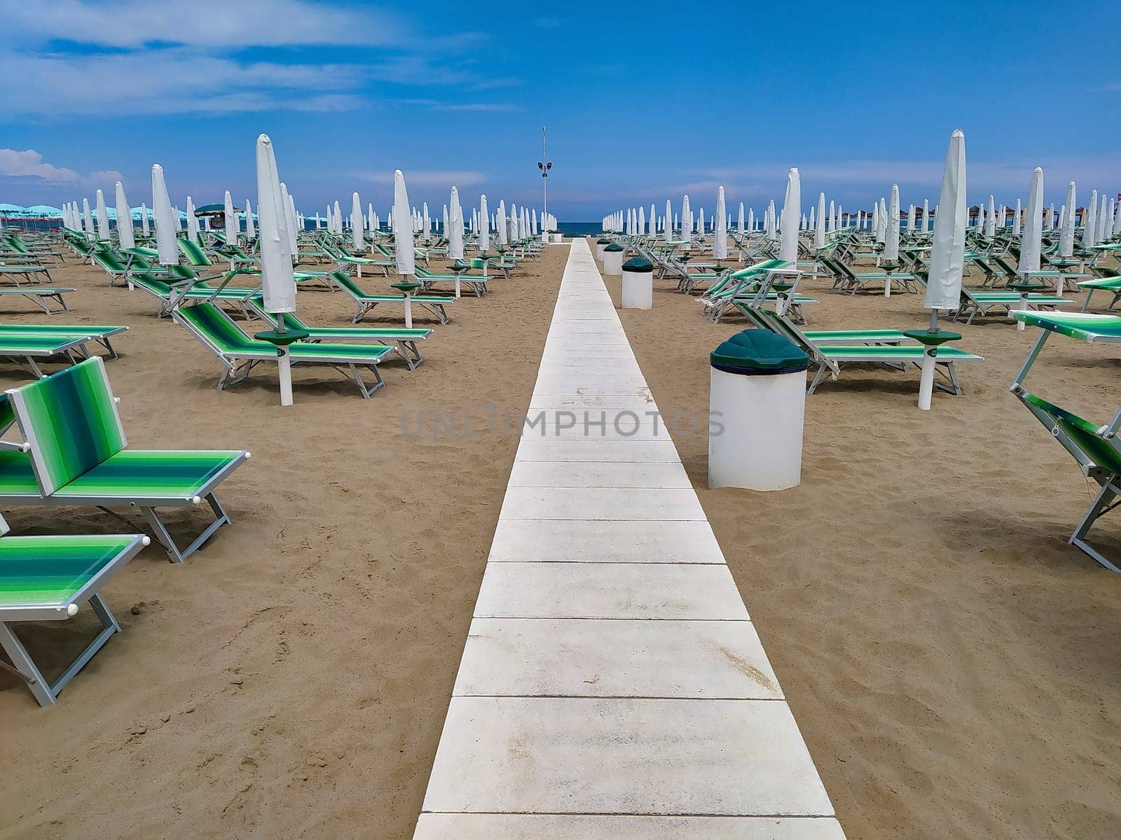 Summer. The sunbeds and parasols on the empty beach
