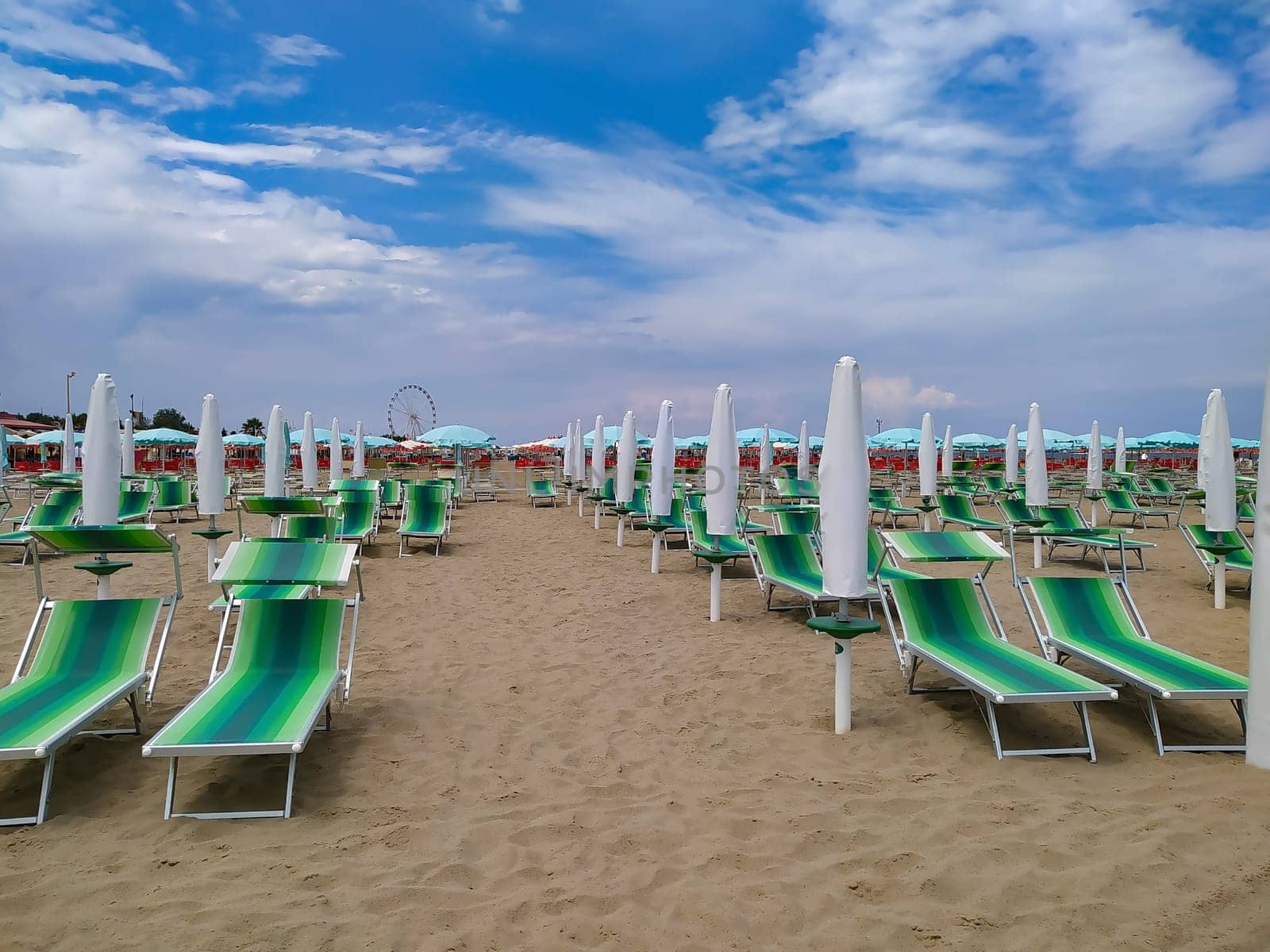 Summer. The sunbeds and parasols on the empty beach