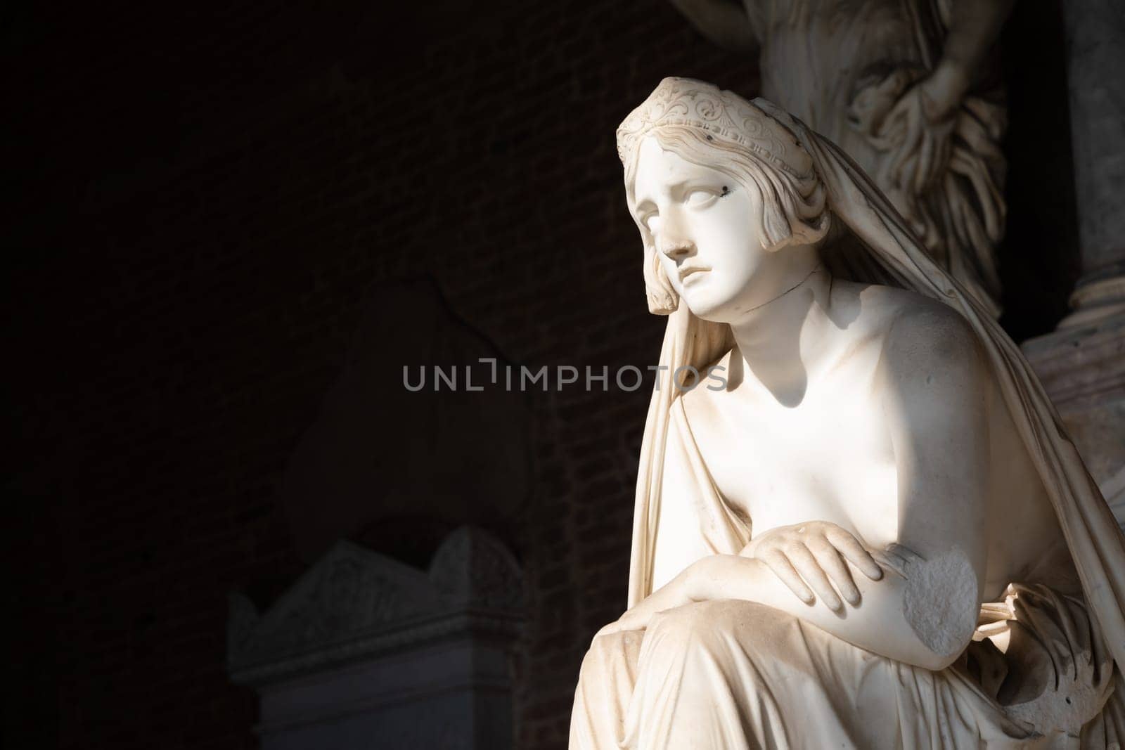 Pisa, Italy - June 2023: catholic cemetery, antique statue of sad woman, by Lorenzo Bartolini, 1841