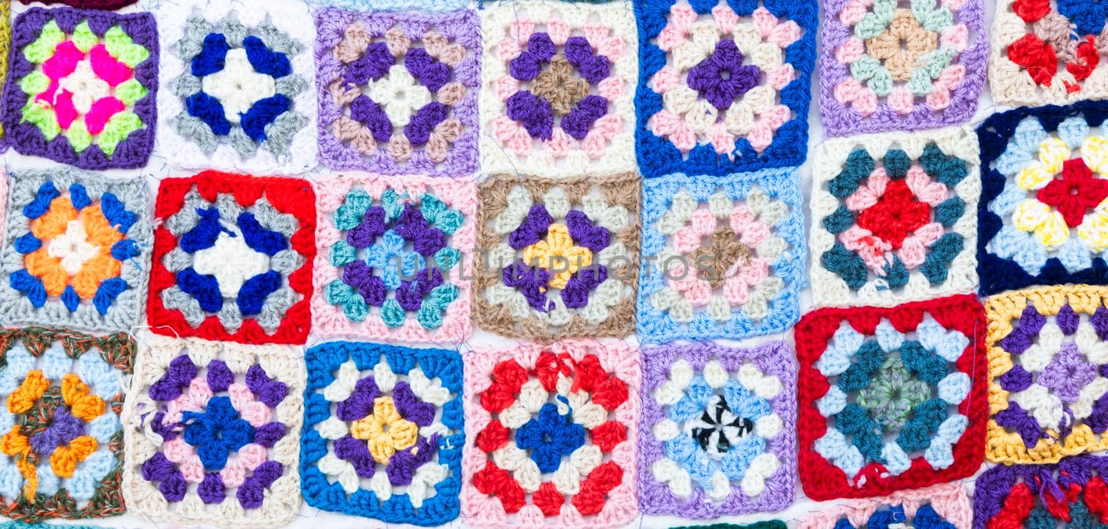 Multi colored blanket in wool, geometric background, retro decorative pattern
