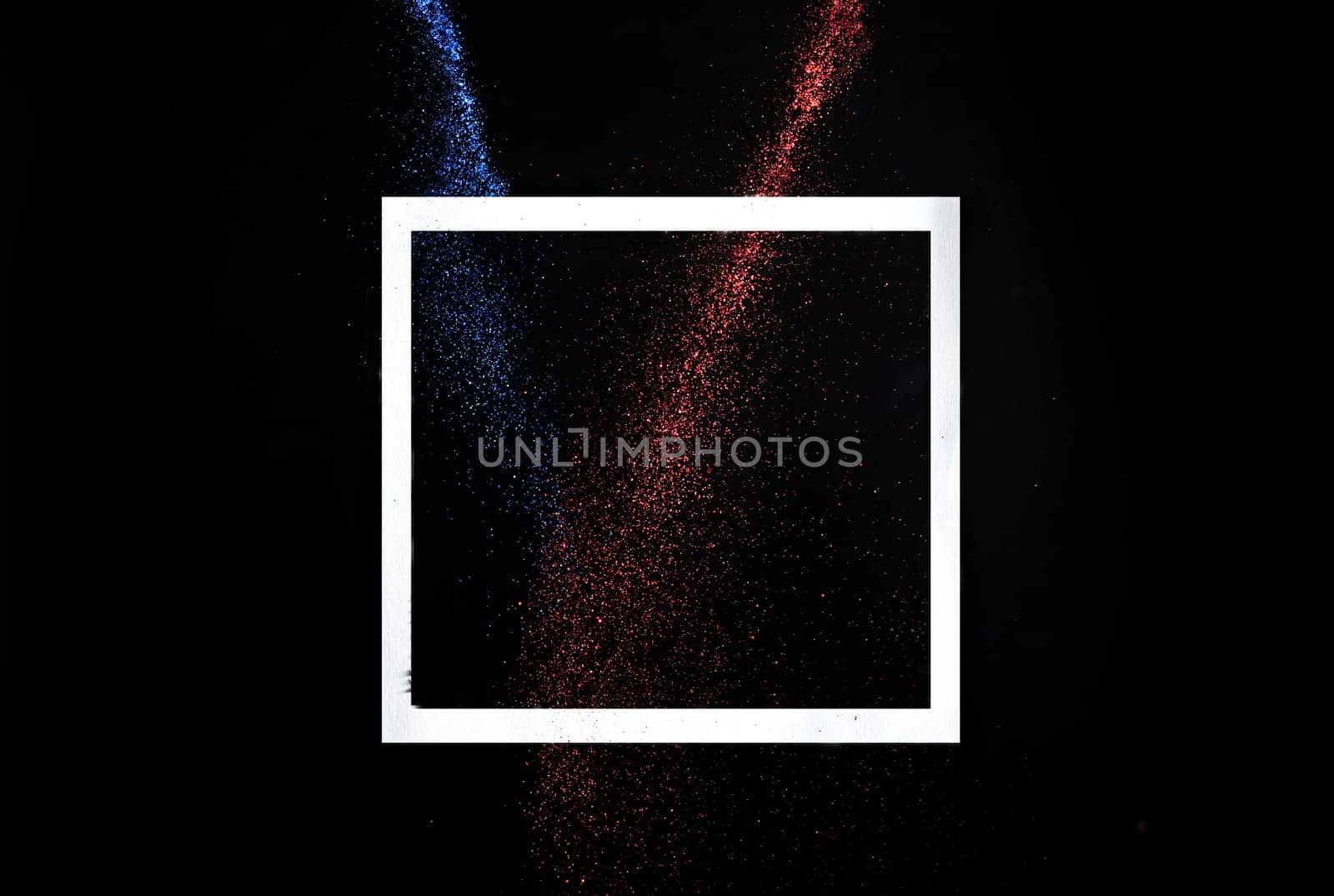 Creative frame concept with neon glitter splash trail on black background. Minimal flat lay design with star dust on dark backdrop. Holiday party modern style trend 2021.