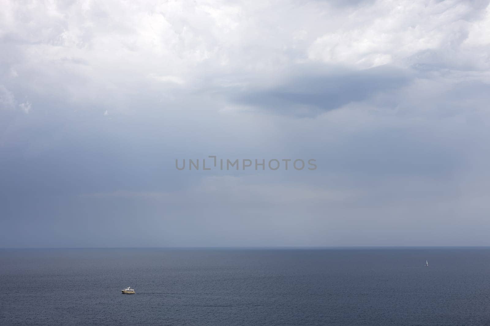 lonely cutter in the sea under a cloudy sky,Lighting before a storm in the Adriatic Sea.