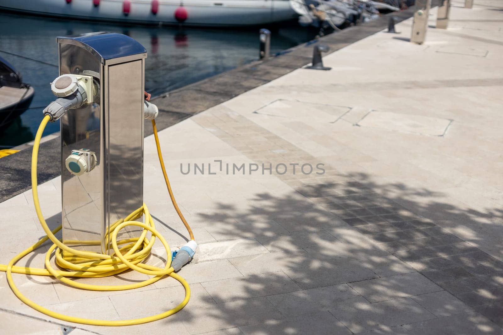 Charging station for boats. Electrical outlets for charging boats in the harbor on the pier by the sea.