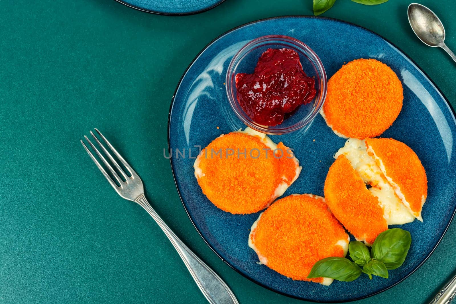 Camembert cheese with berry sauce or jam.