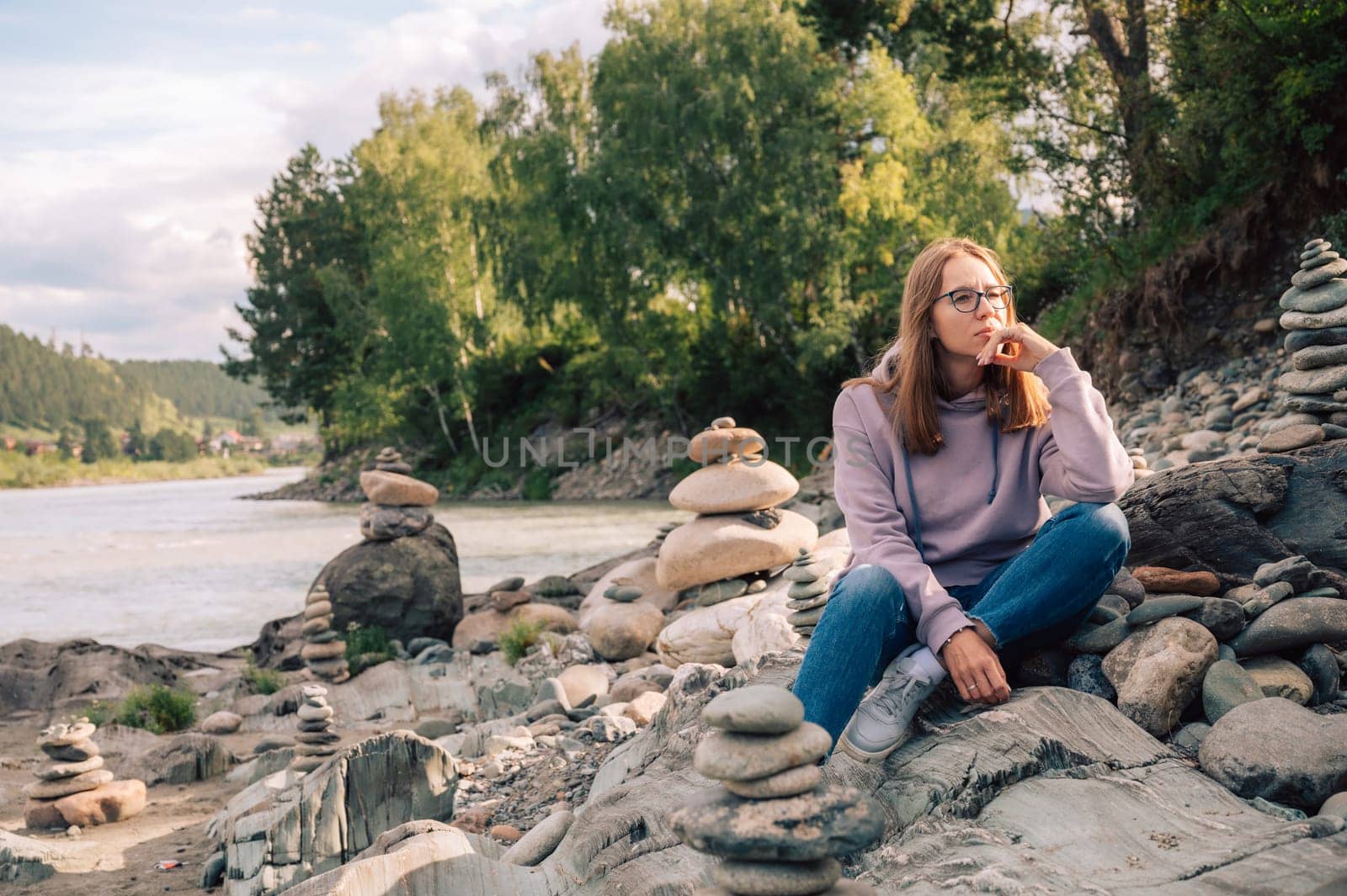 Woman at the river Katun at summer day. Trip on Altai Mountains in Altai Republic