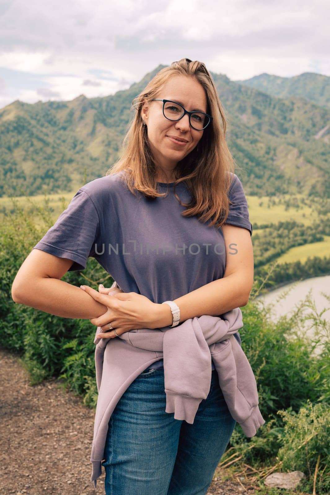 Woman at the river Katun at summer day. Trip on Altai Mountains in Altai Republic