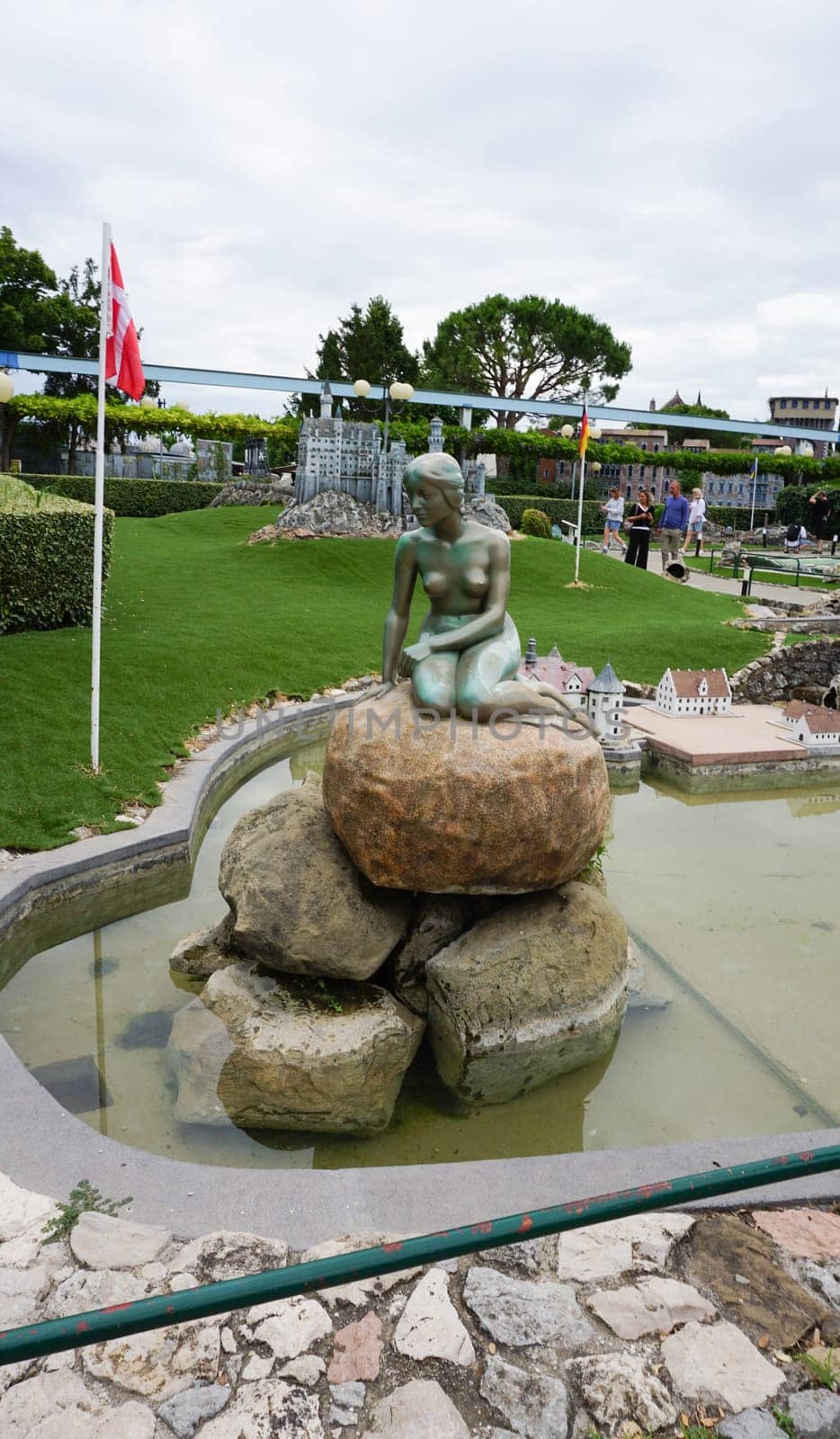 Viserba, Italy - June 25, 2024: The The Little Mermaid Statue in Copenhagen at Theme park Italy in Miniature or Italia in Miniatura in Rimini, Italy - Reproduction of famous attractions in a small scale