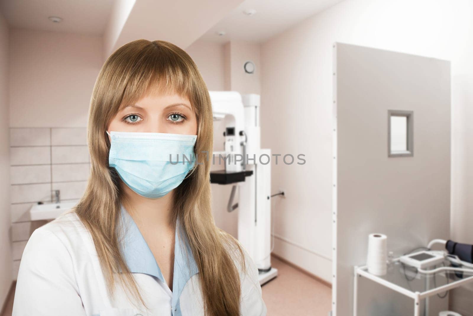 Female doctor mammologist or radiologist working in the room with equipment for breast x-ray