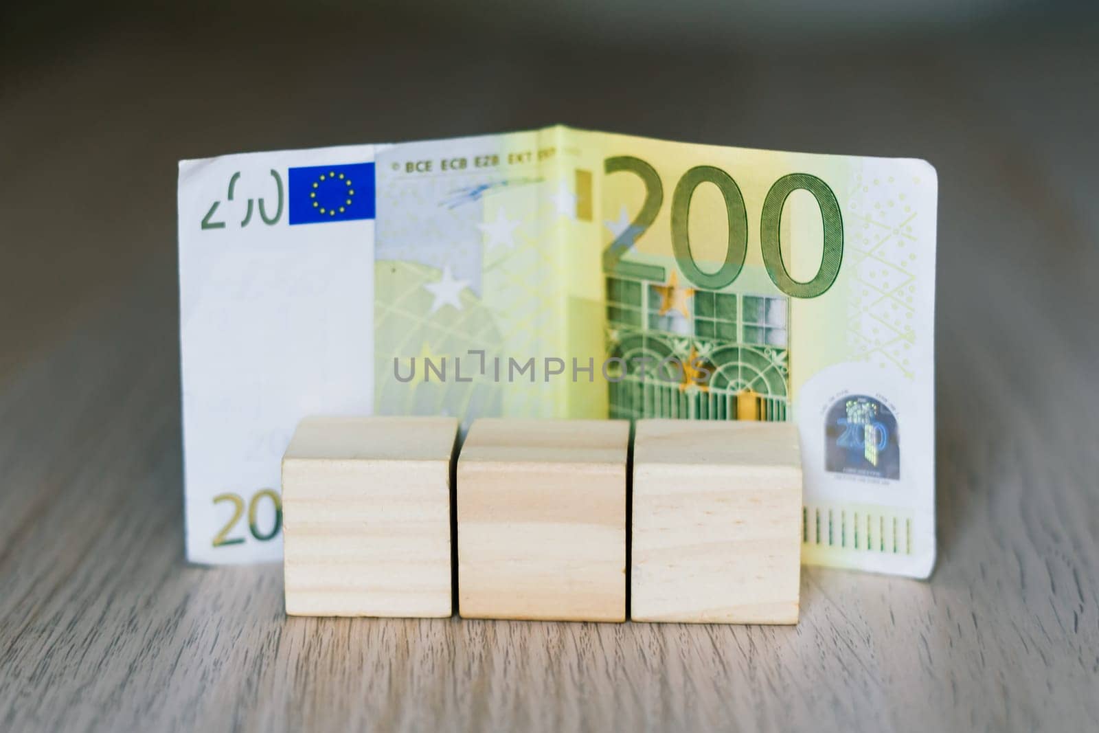 Wooden cubes blocks, money 200 Euro banknotes. Management big salary career conception