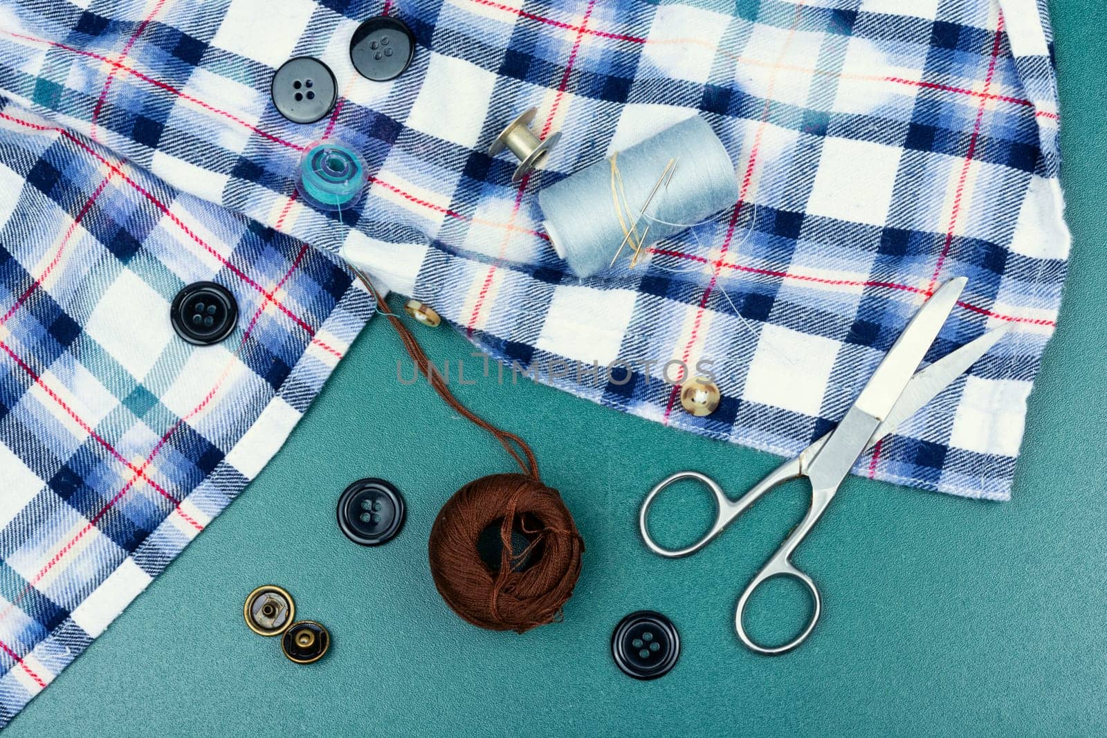 Colored threads and needles for sewing. Different sewing accessories