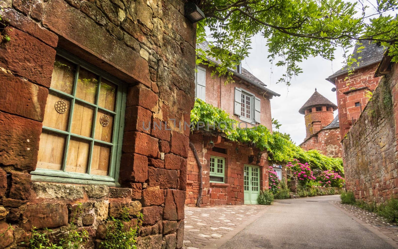 Red houses photographed from the street in Collonges-la-Rouge, one of the most beautiful villages in France, Corrèze
