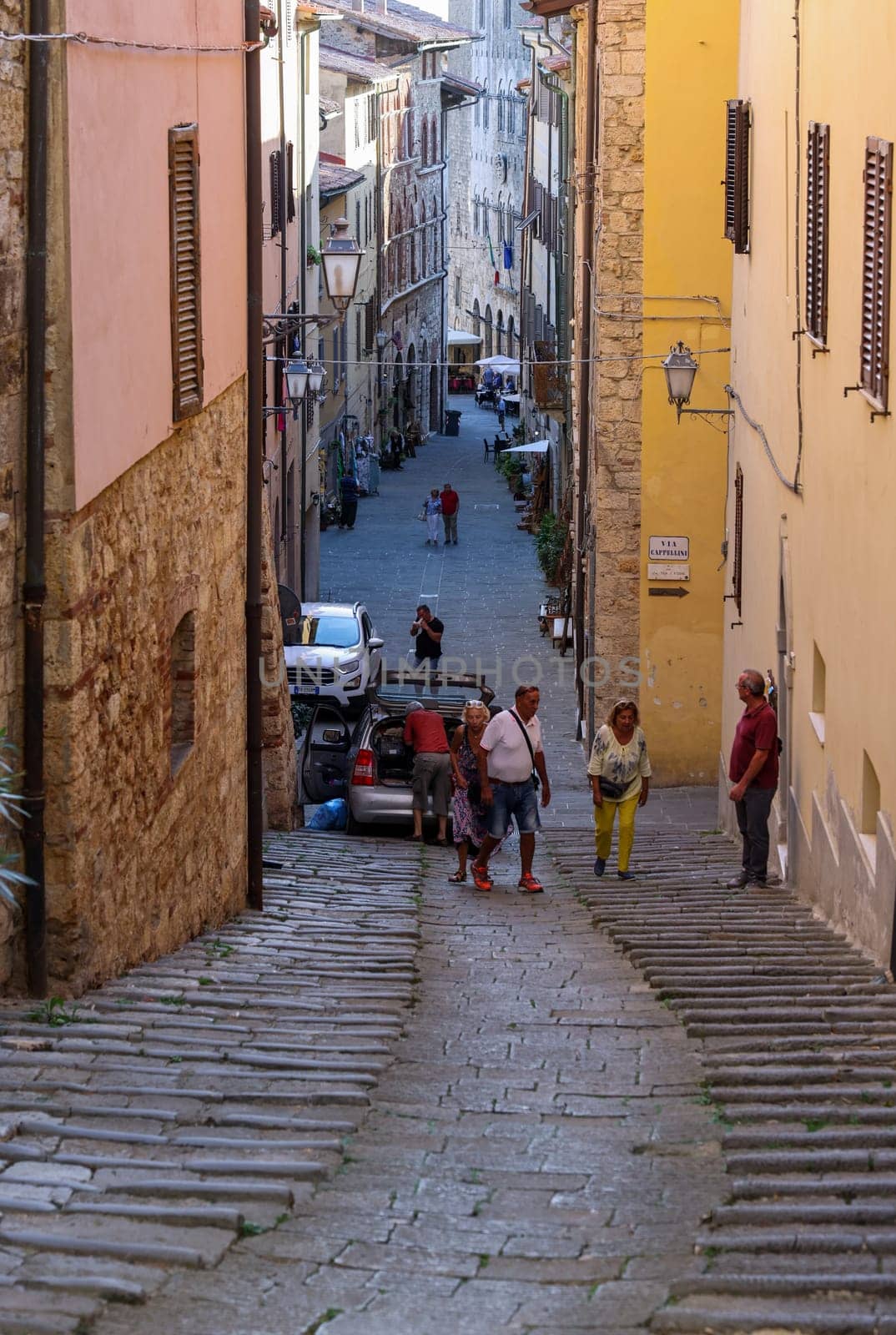 Massa Marittima, Italy - Sept 11, 2022: Steep and narrow street in old town of Massa Marittima, Italy