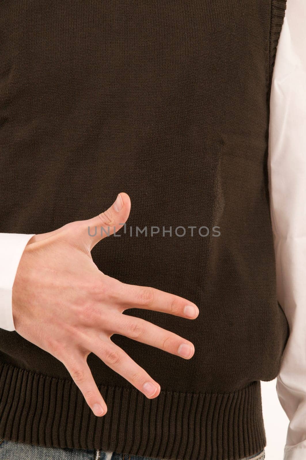 A male hand held in front of the stomach symbolizes the number 5 with the fingers.