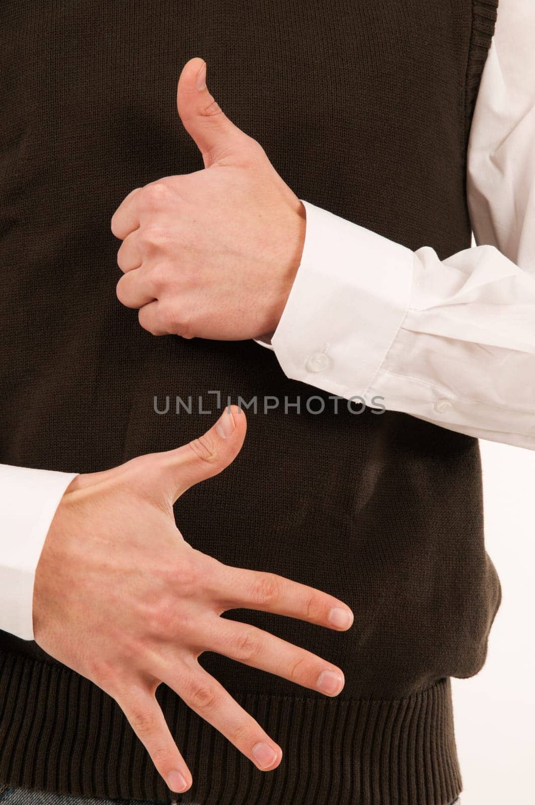 A male hand held in front of the stomach symbolizes the number 6 with the fingers.