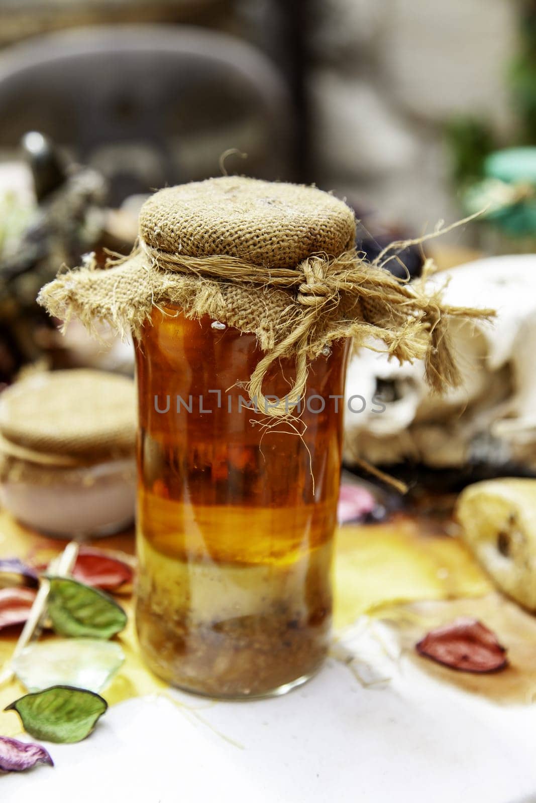 Detail of a glass jar with herbs for witchcraft